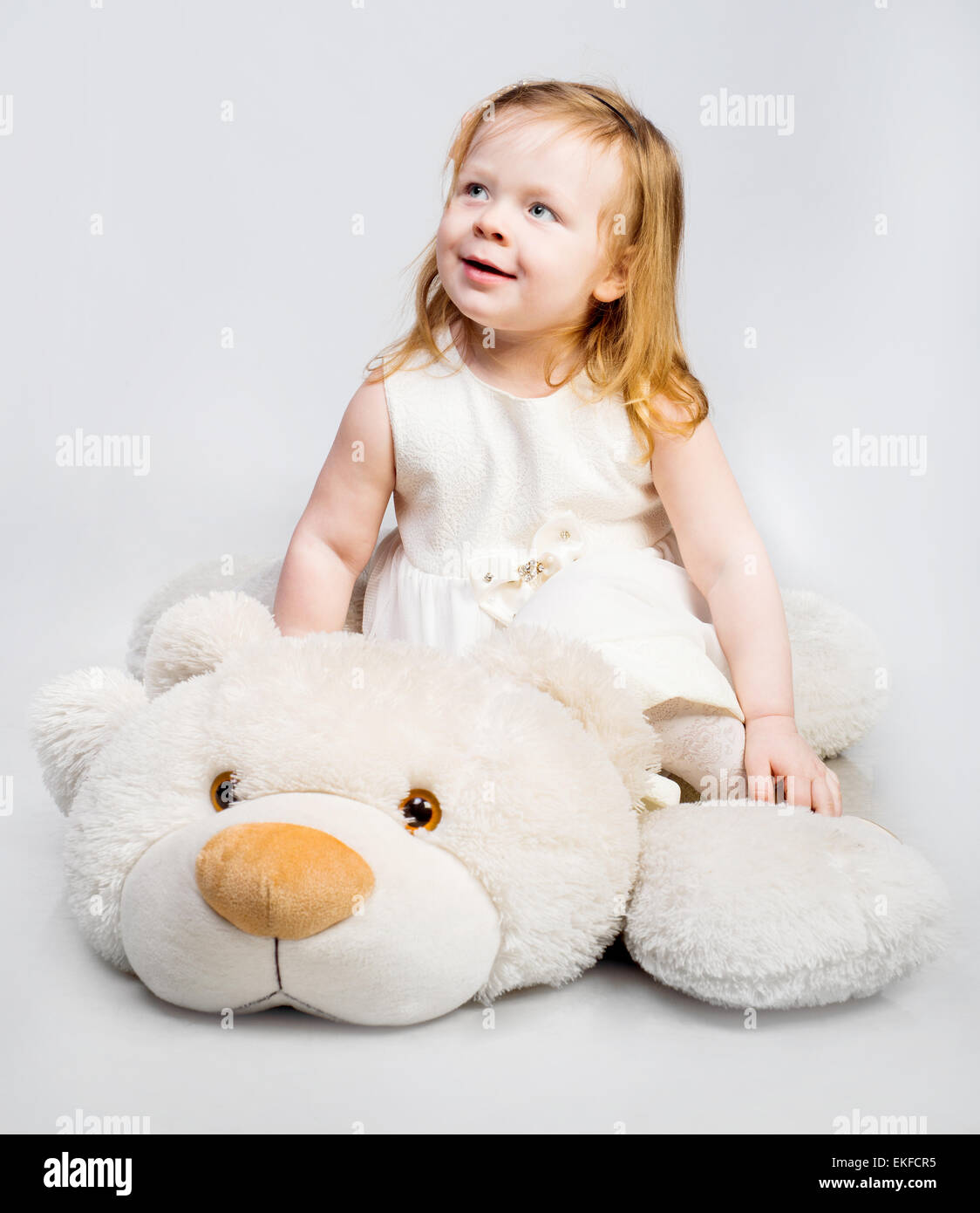 Little girl with toy bear Stock Photo