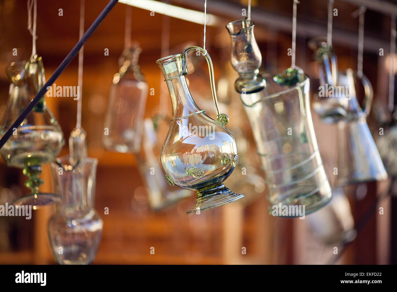 decanters of bohemian glass hanging on hooks Stock Photo
