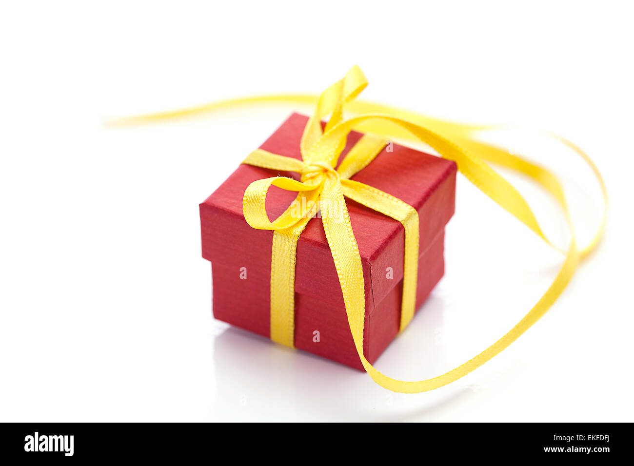 red gift box with a yellow ribbon isolated on white Stock Photo - Alamy