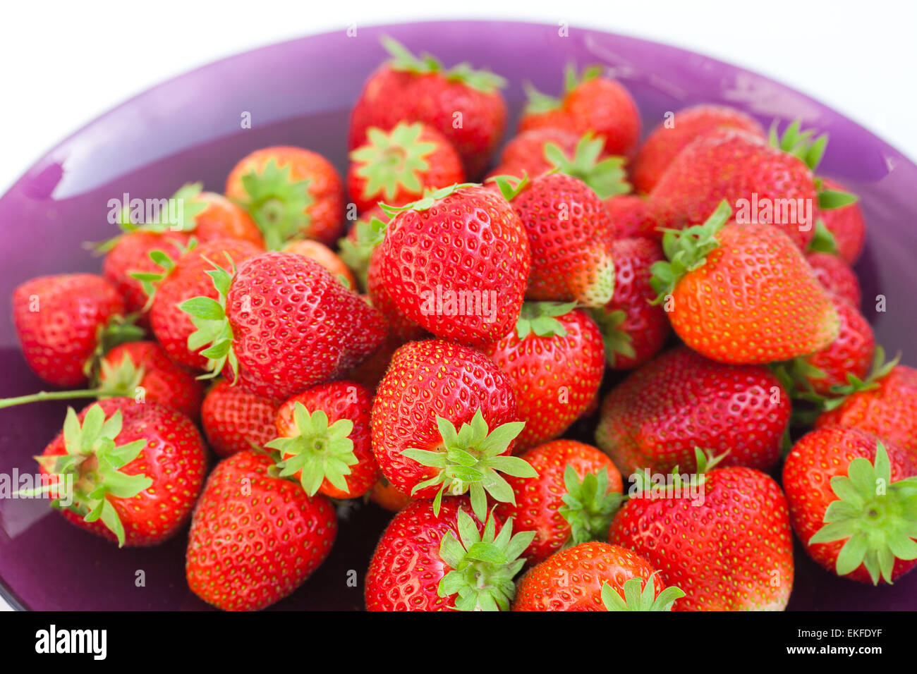 strawberries in a glass plate isolated on white Stock Photo - Alamy