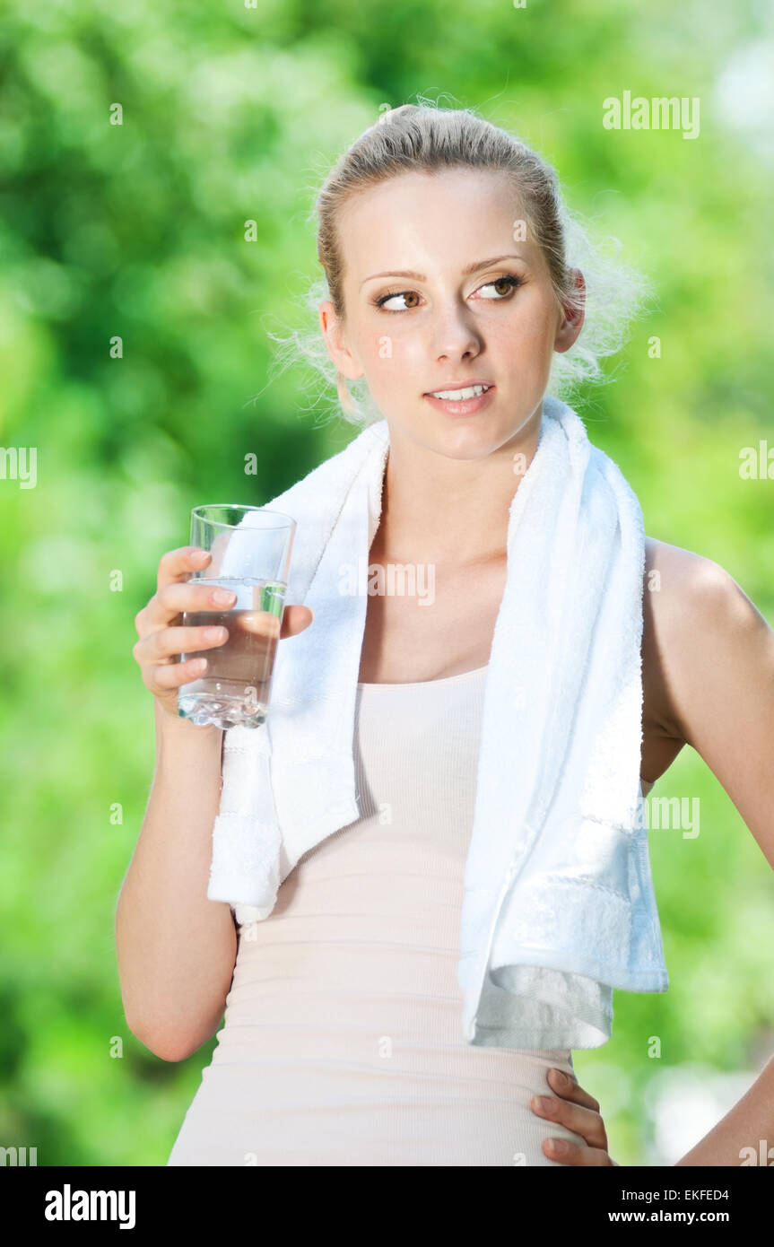 Woman drinking water after exercise Stock Photo Alamy
