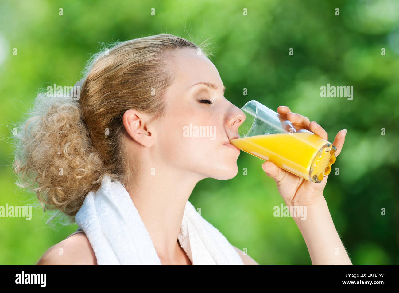 Woman drinking juice after exercise Stock Photo Alamy