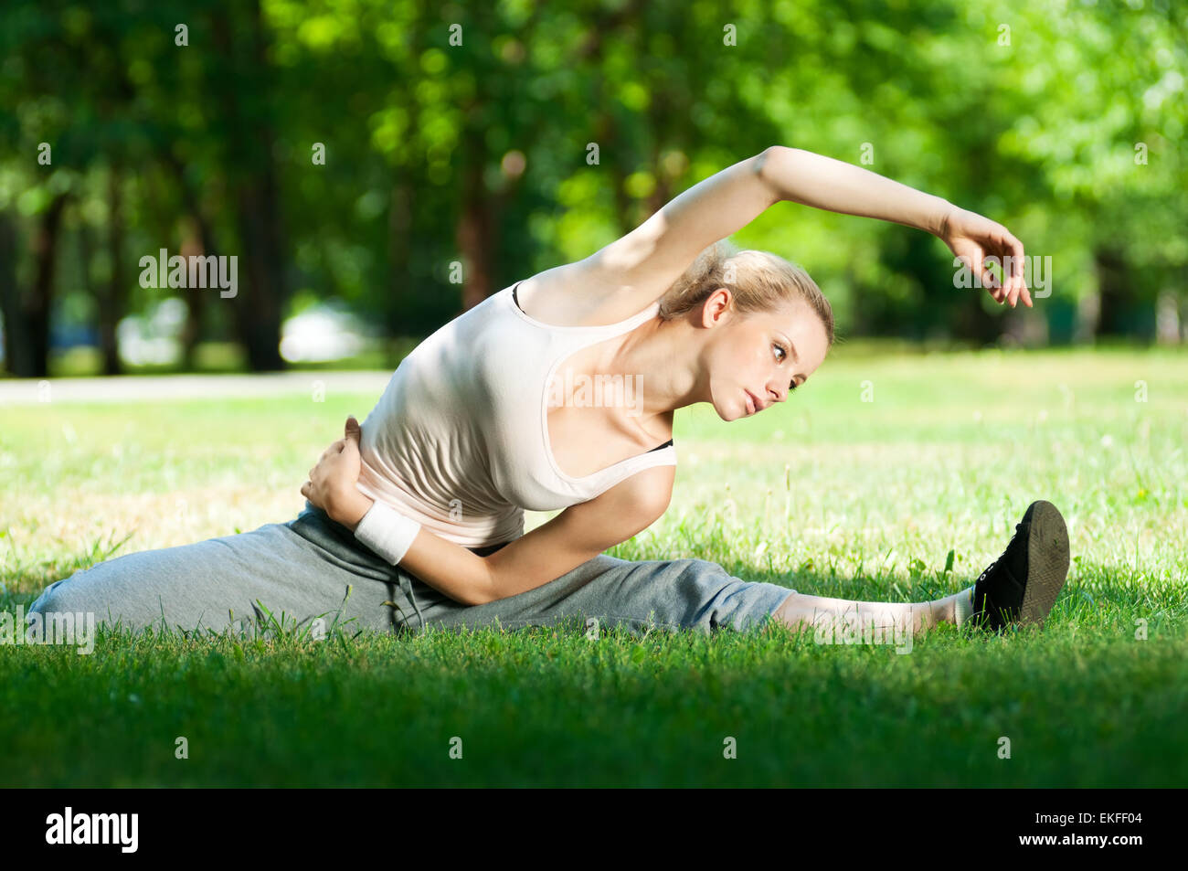 Young woman doing yoga exercise Stock Photo - Alamy