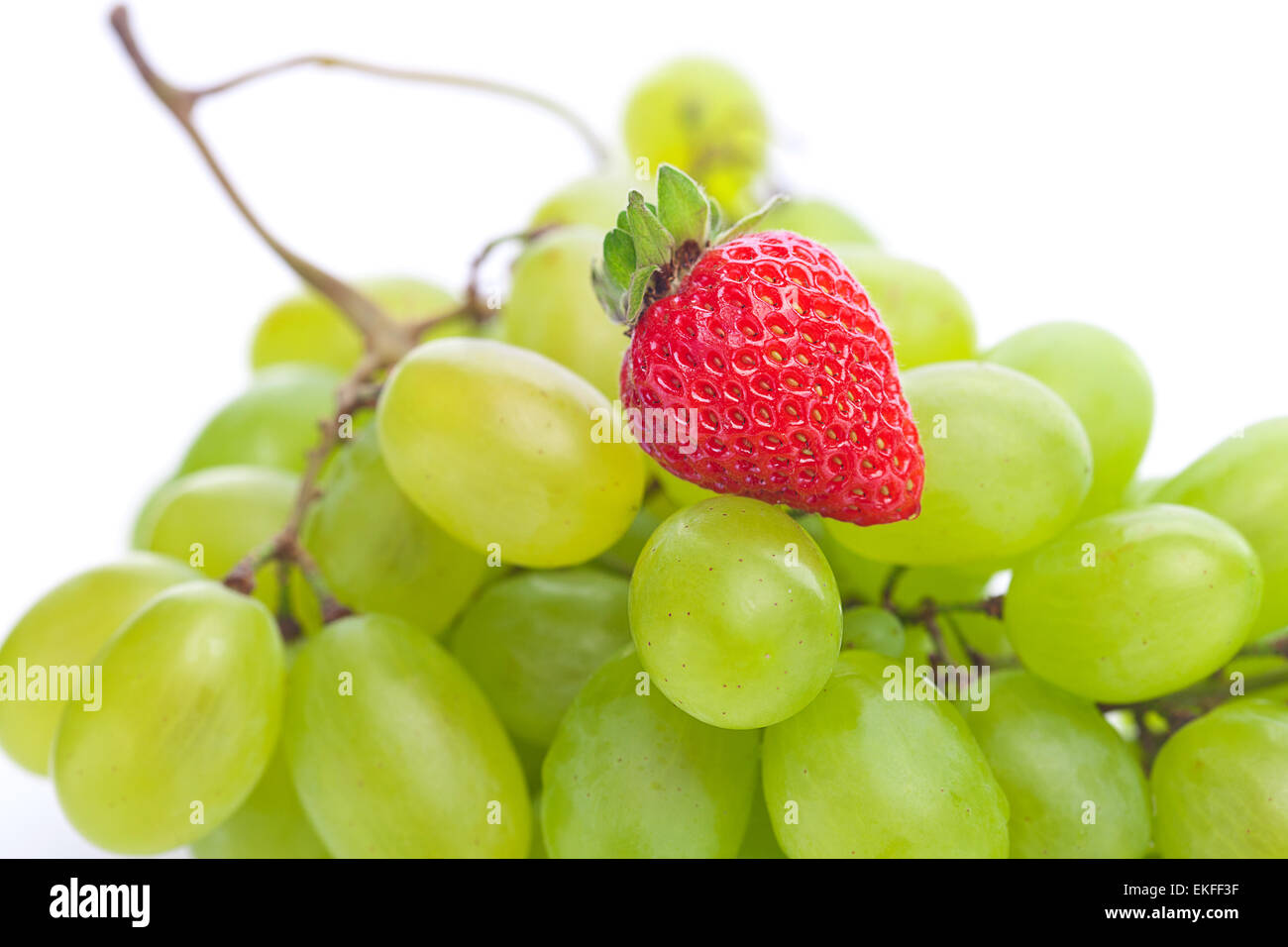 bunch of white grapes and strawberries isolated on white Stock Photo