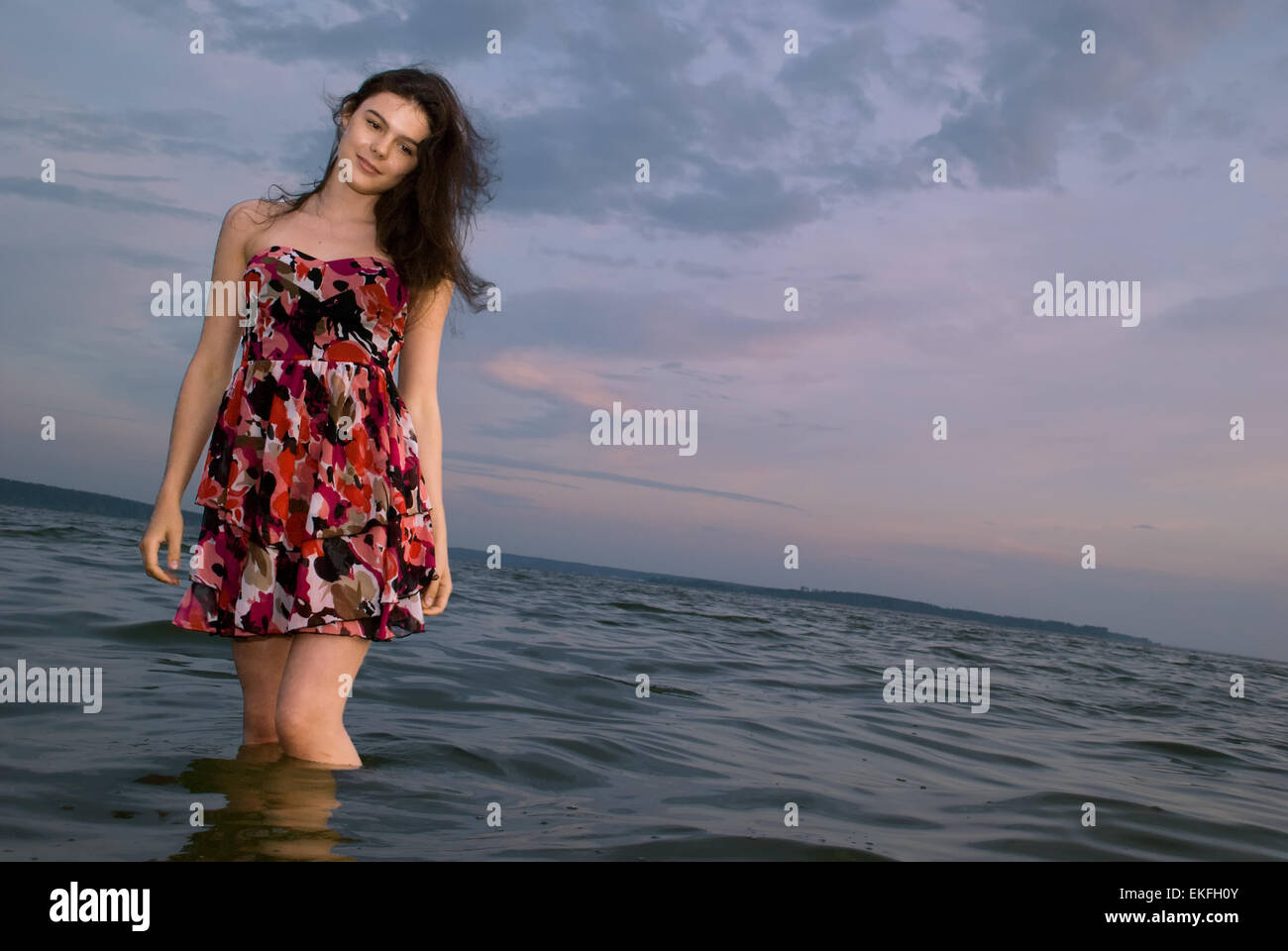 Beautiful girl in the water on sea coast Stock Photo - Alamy