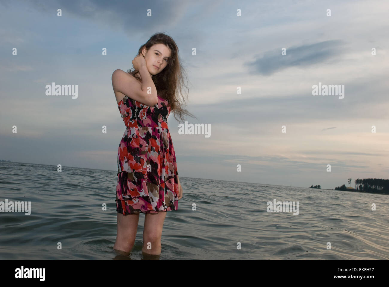 Beautiful girl in the water on sea coast Stock Photo - Alamy