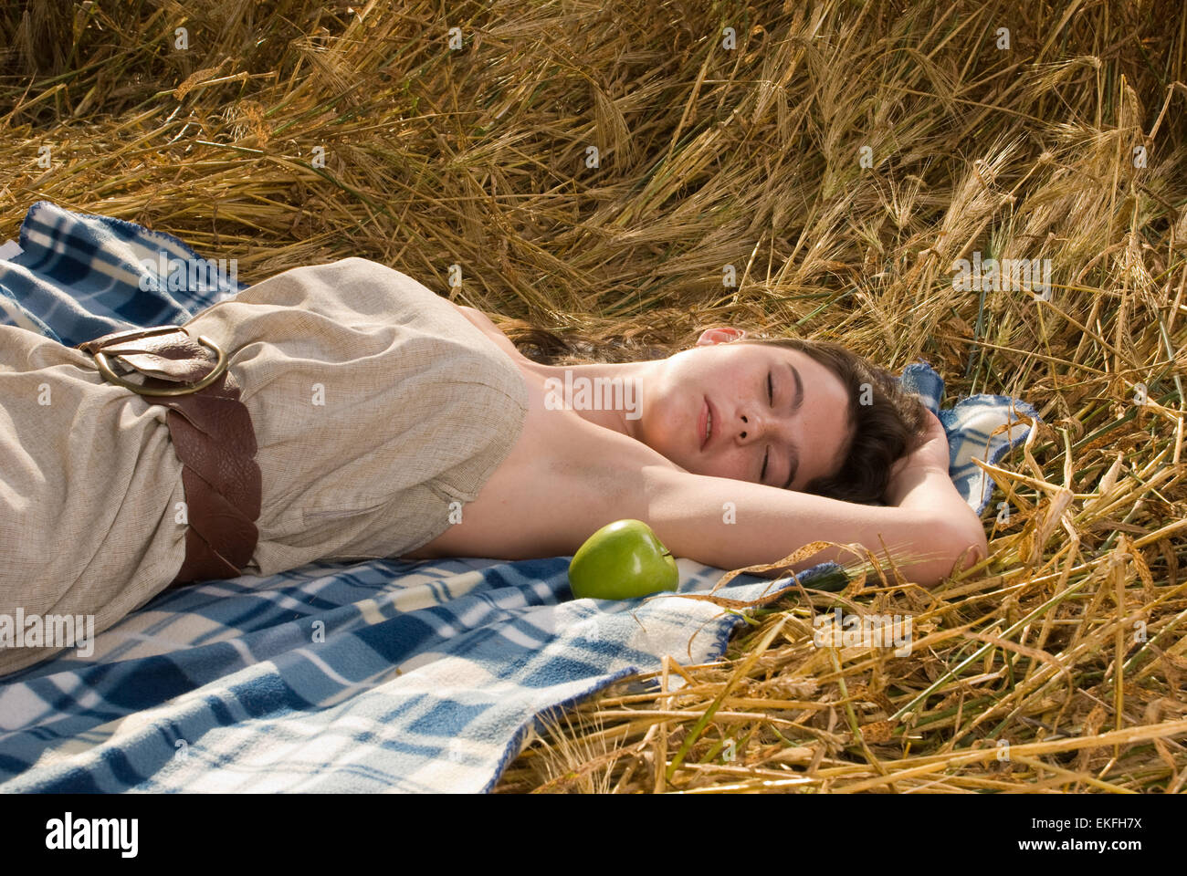 Beautiful slavonic girl on picnic in wheat field with apple Stock Photo ...