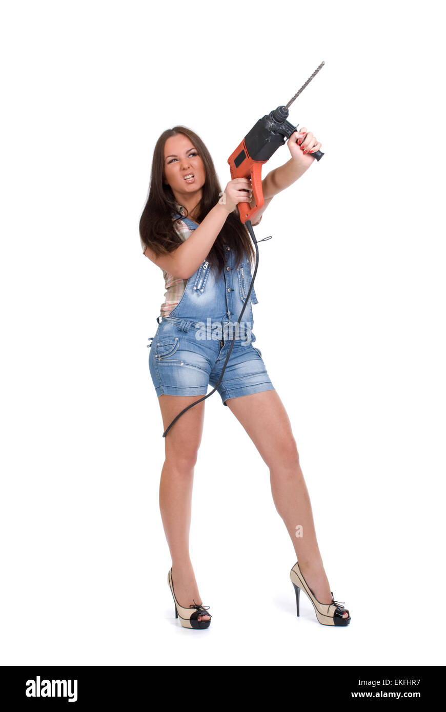 Young woman holding hammer drill hires stock photography and images
