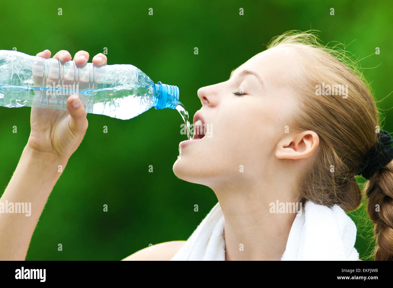 Woman drinking water after exercise Stock Photo Alamy