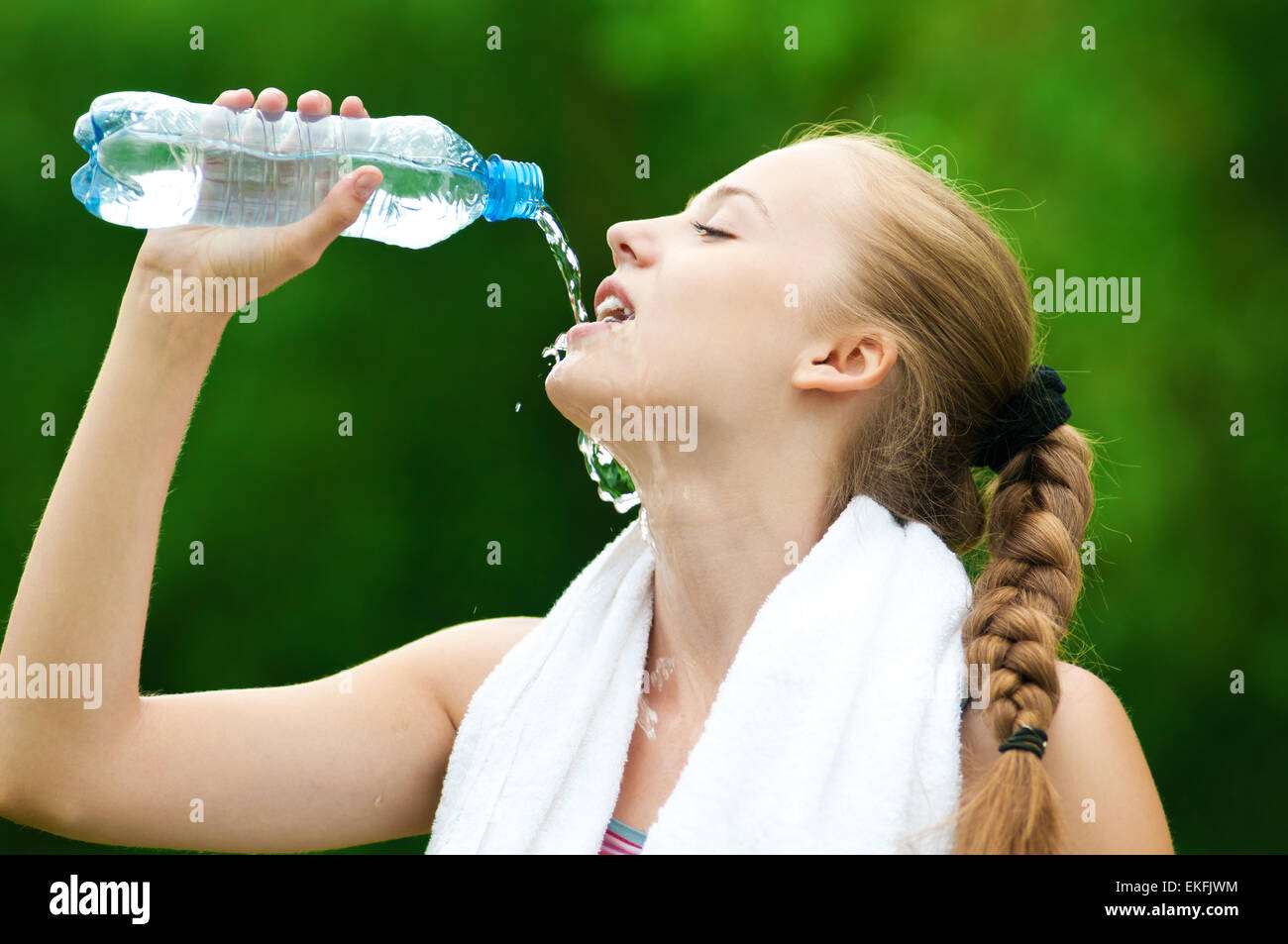 Woman drinking water after exercise Stock Photo Alamy