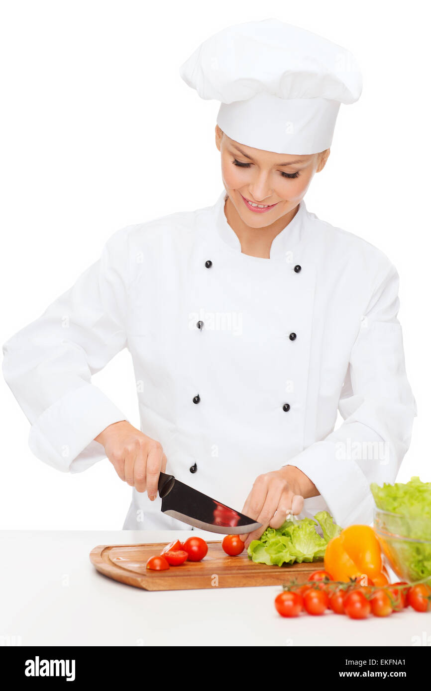 smiling female chef chopping vagetables Stock Photo - Alamy