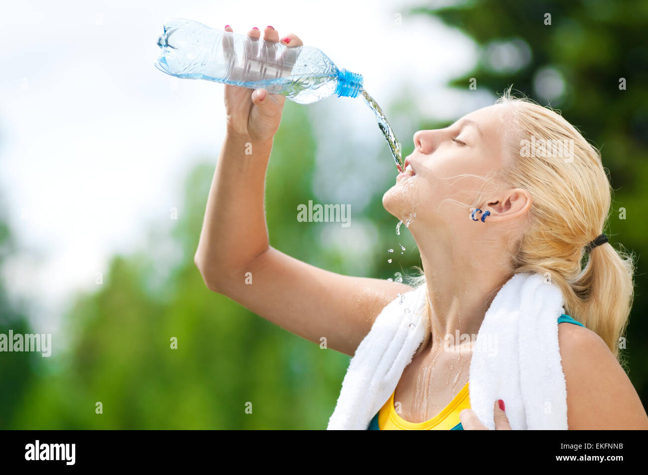 Woman drinking water after exercise Stock Photo Alamy