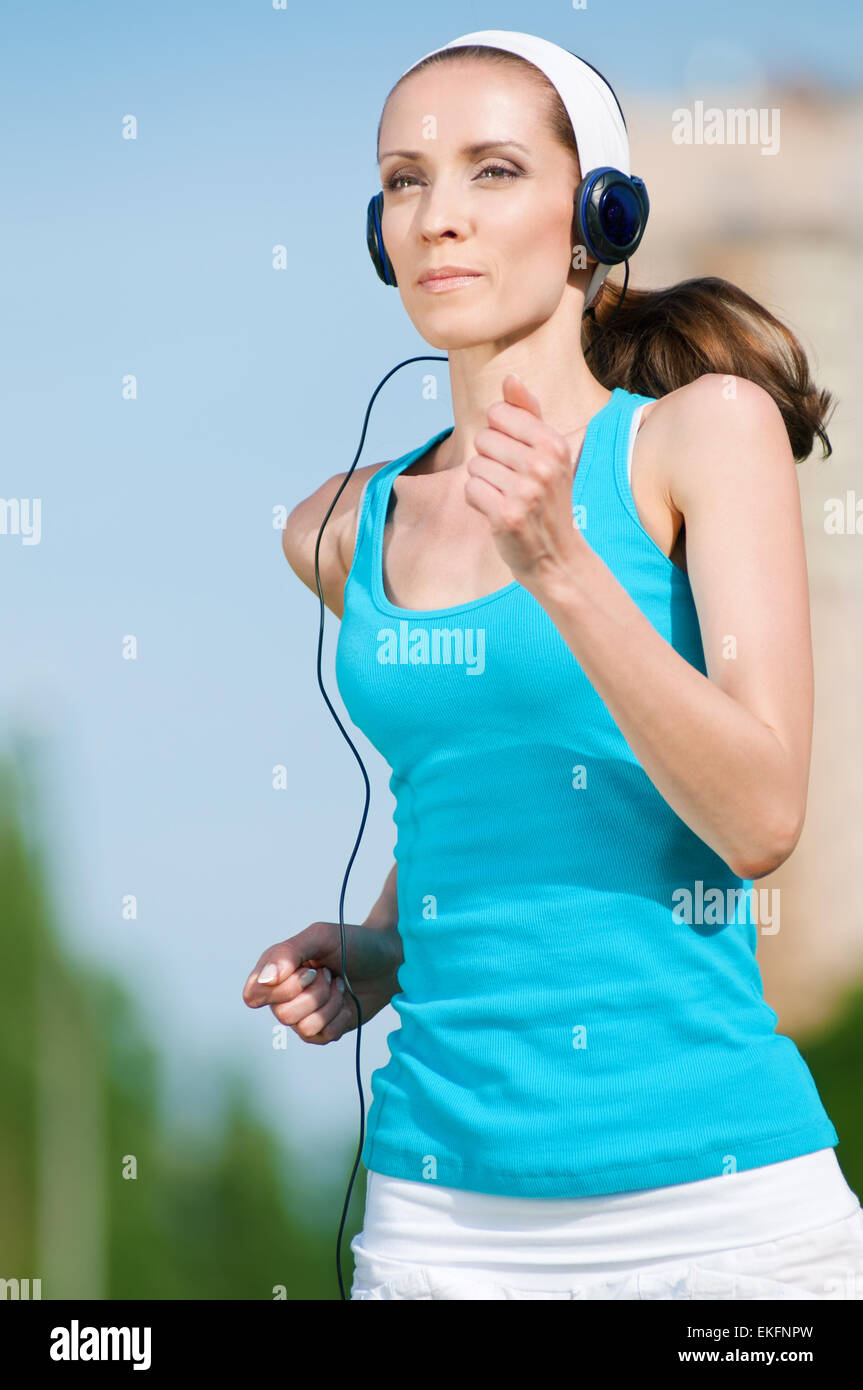 Beautiful woman running in green park Stock Photo Alamy