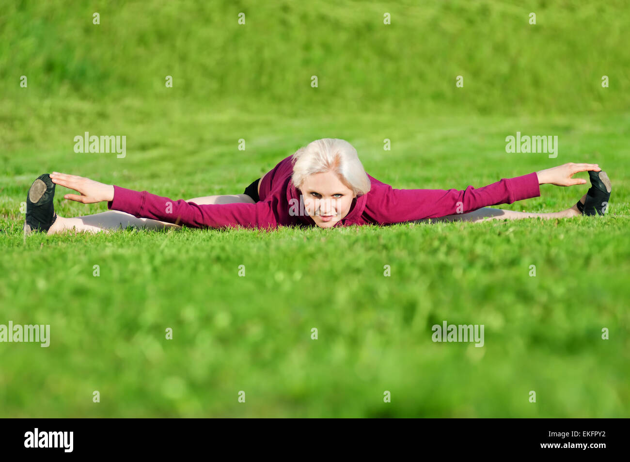 Beautiful woman doing yoga stretching exercise Stock Photo - Alamy