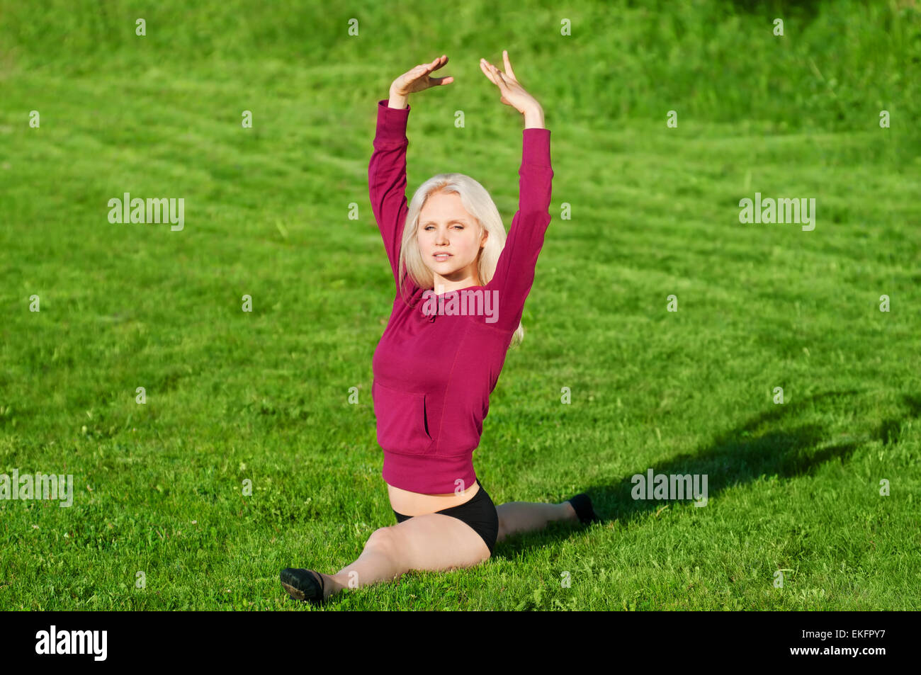 Beautiful woman doing yoga stretching exercise Stock Photo - Alamy