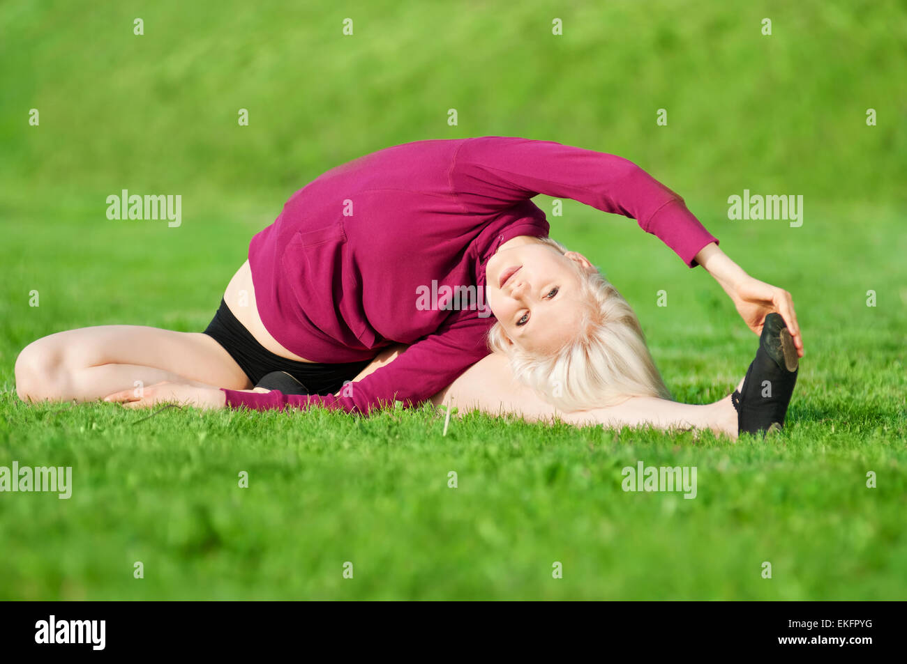 Beautiful woman doing yoga stretching exercise Stock Photo - Alamy