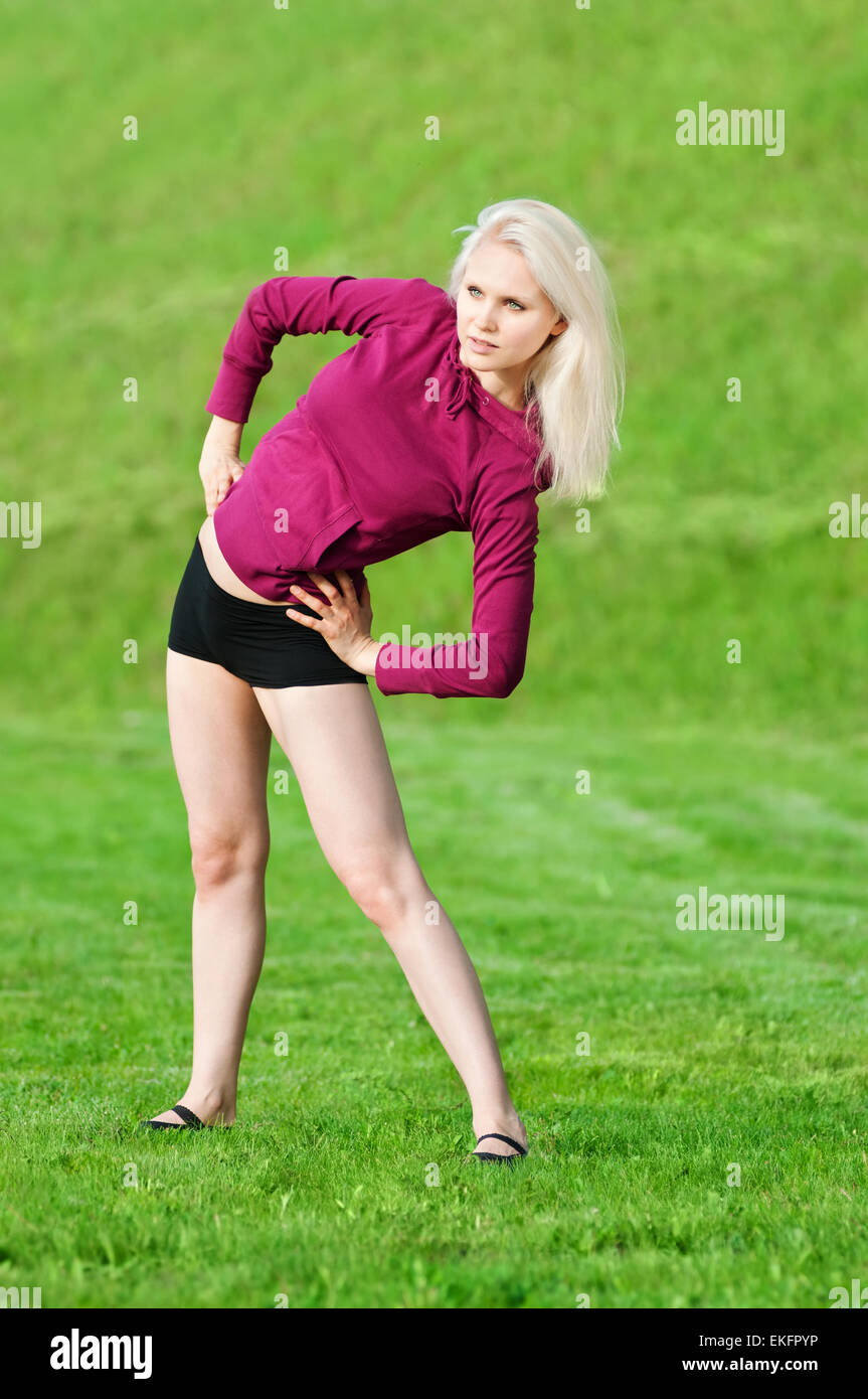 Beautiful woman doing yoga stretching exercise Stock Photo - Alamy