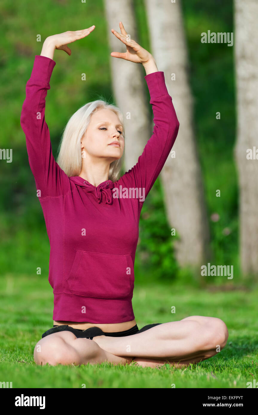 Beautiful woman doing yoga stretching exercise Stock Photo - Alamy