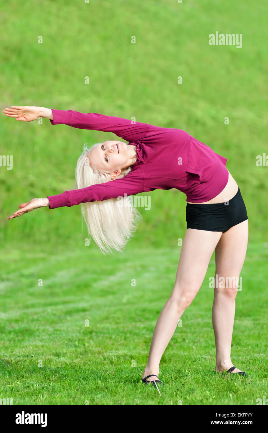 Beautiful woman doing yoga stretching exercise Stock Photo - Alamy