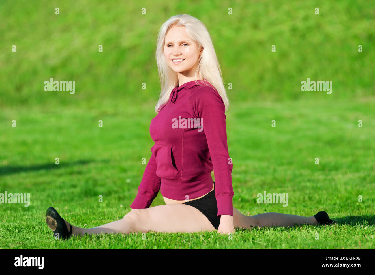 Beautiful woman doing yoga stretching exercise Stock Photo - Alamy