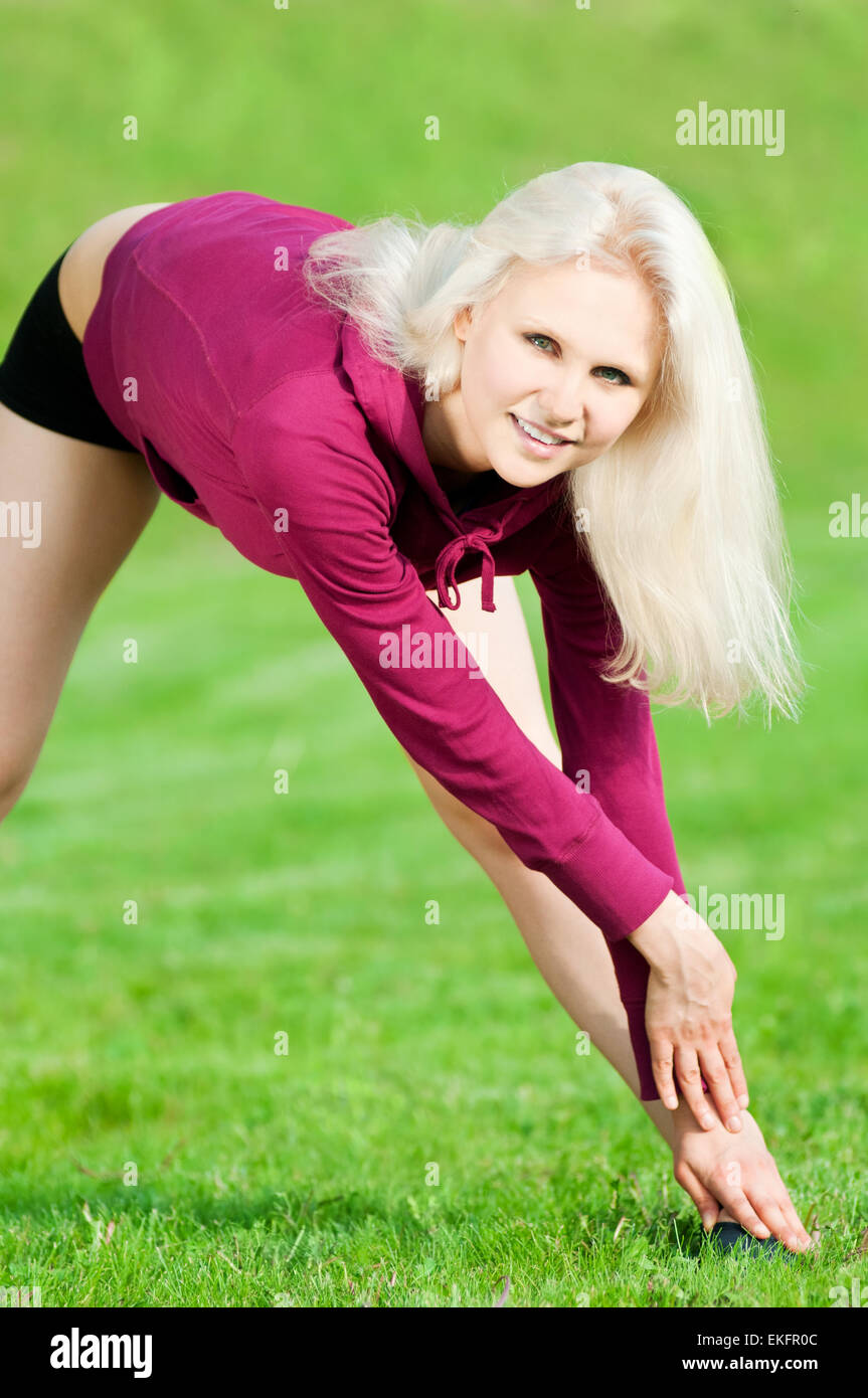 Beautiful woman doing yoga stretching exercise Stock Photo - Alamy