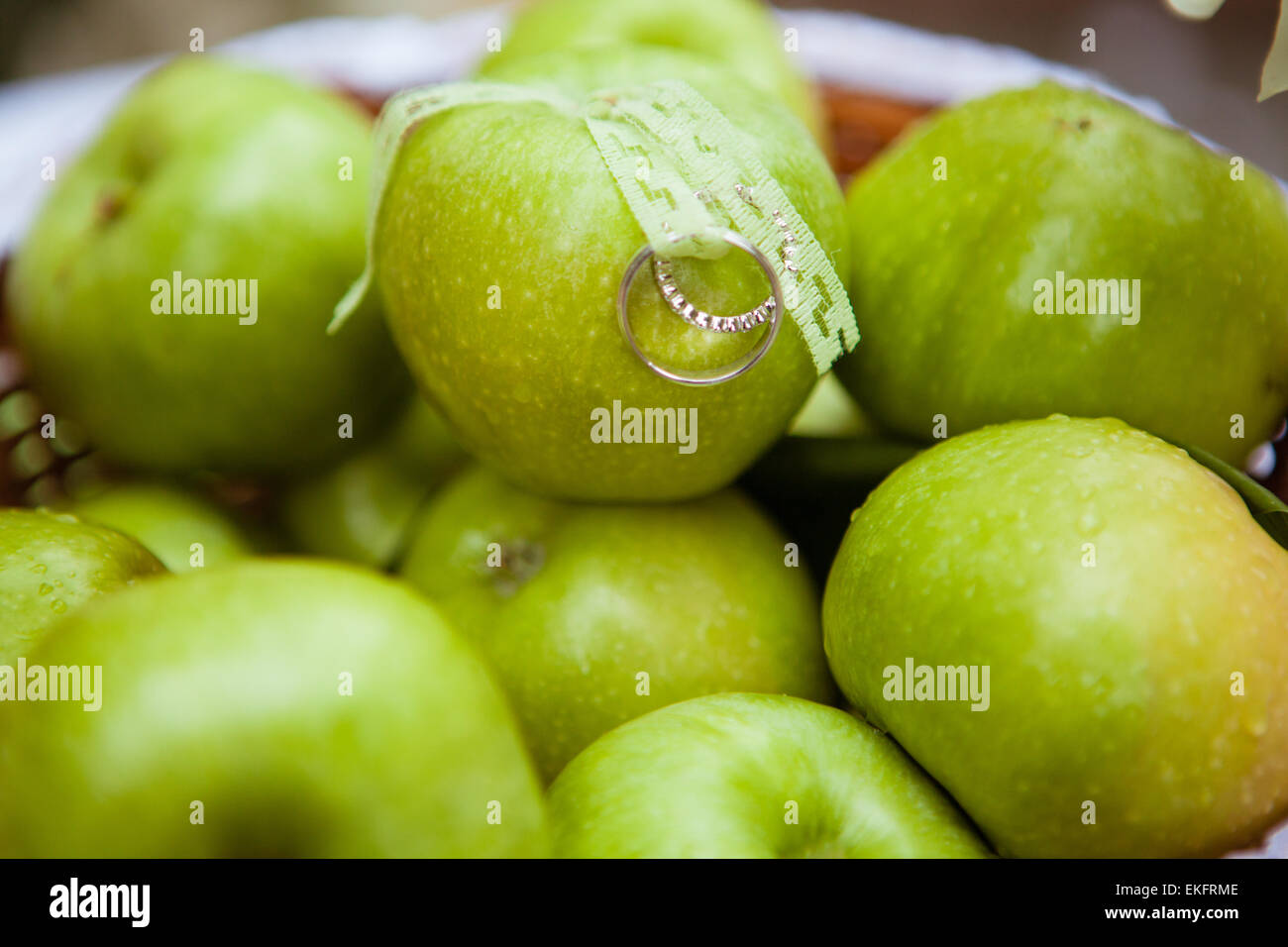 wedding rings on the green apples Stock Photo