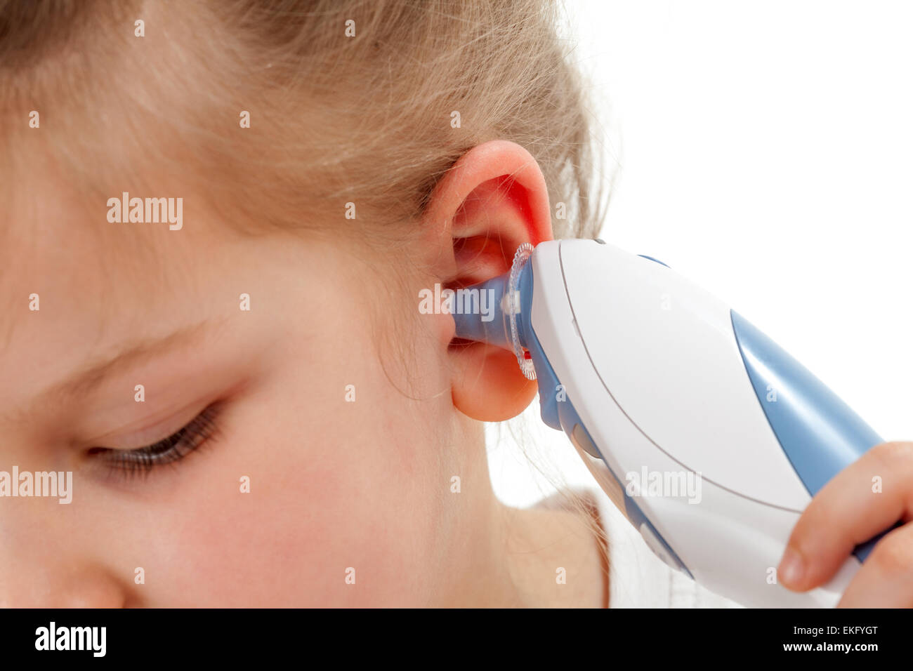 Taking temperature with ear thermometer Stock Photo
