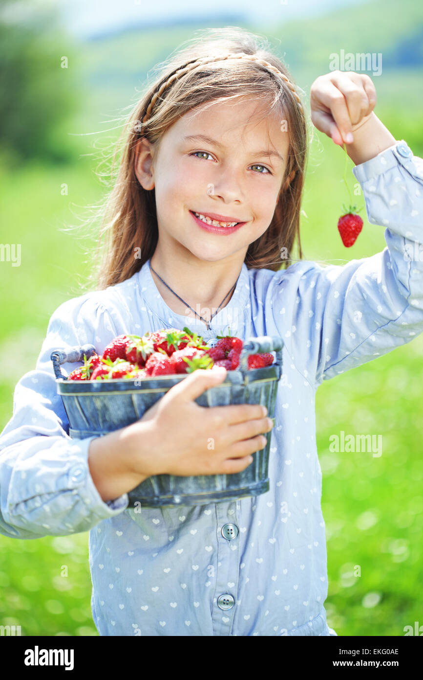 Child eating strawberries in a field Stock Photo Alamy