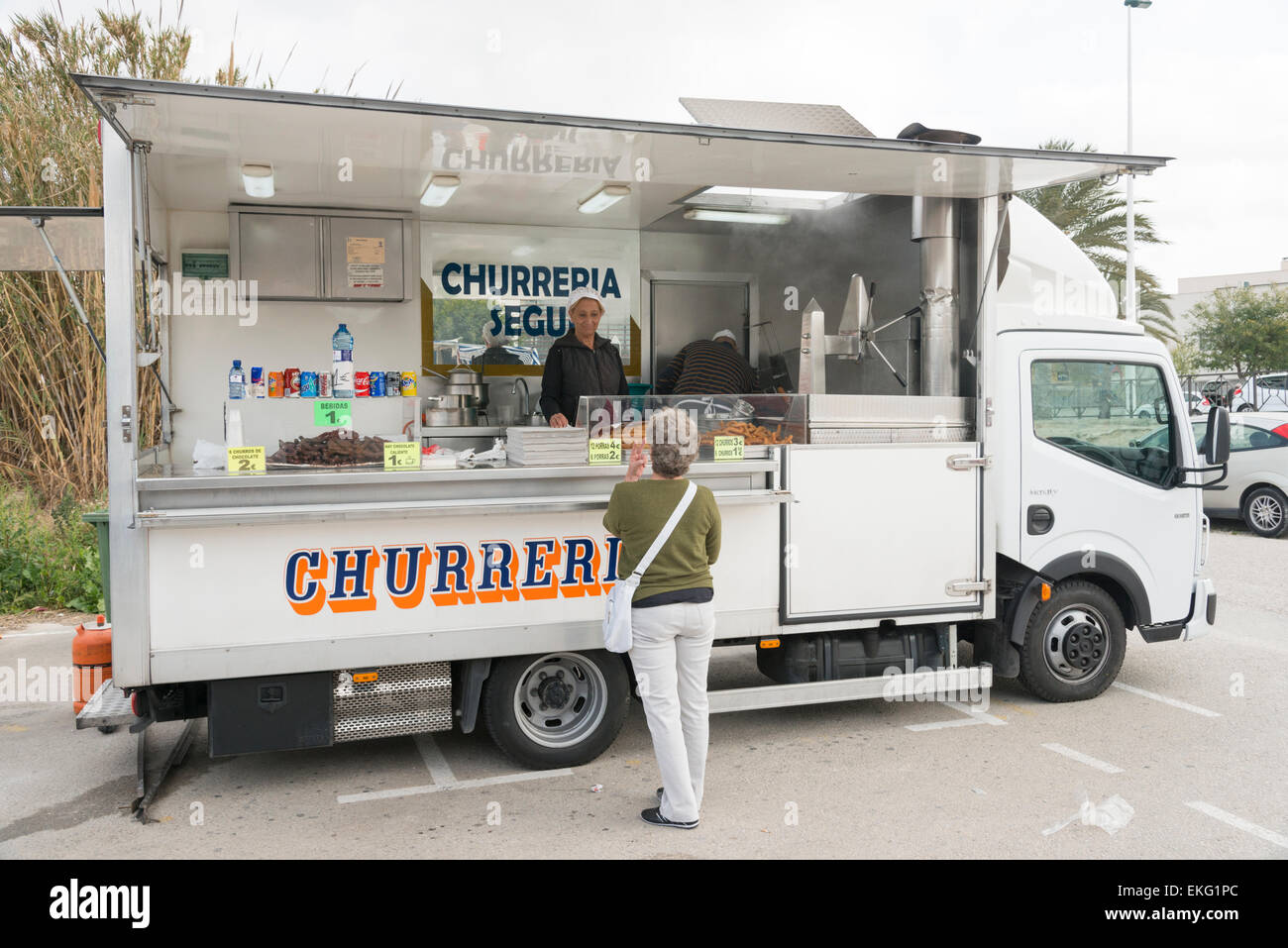 A churros van or Churreria selling Spanish donut cuisine in a market in Moriara, Spain Stock Photo