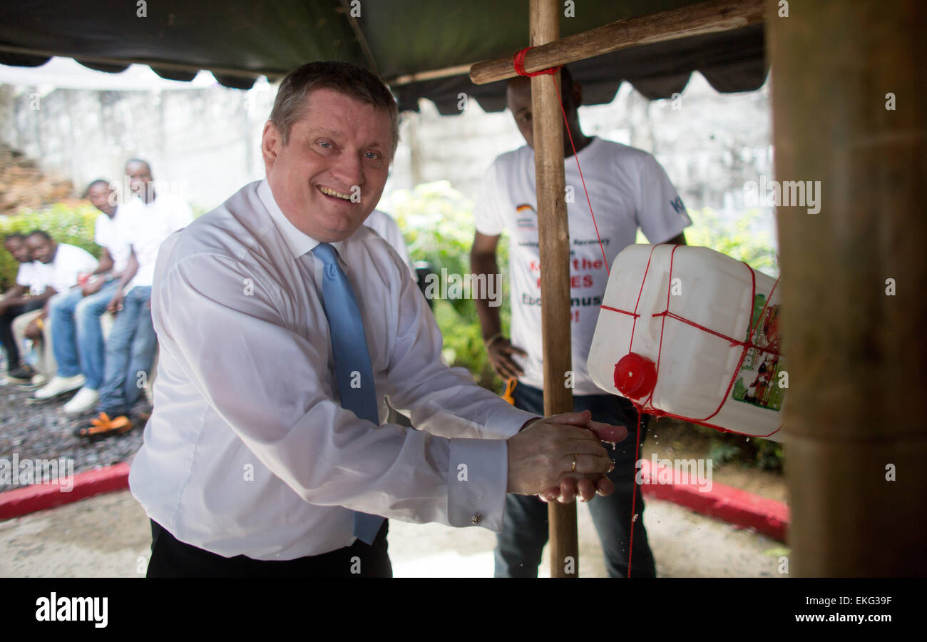 Monrovia, Liberia. 10th Apr, 2015. German Federal Minister of Health Hermann Groehe washes his hands at the Society for International Cooperation in Monrovia, Liberia, 10 April 2015. German Ministers Groehe and Mueller visited the society during their trip to Liberia. Photo: KAY NIETFELD/dpa/Alamy Live News Stock Photo