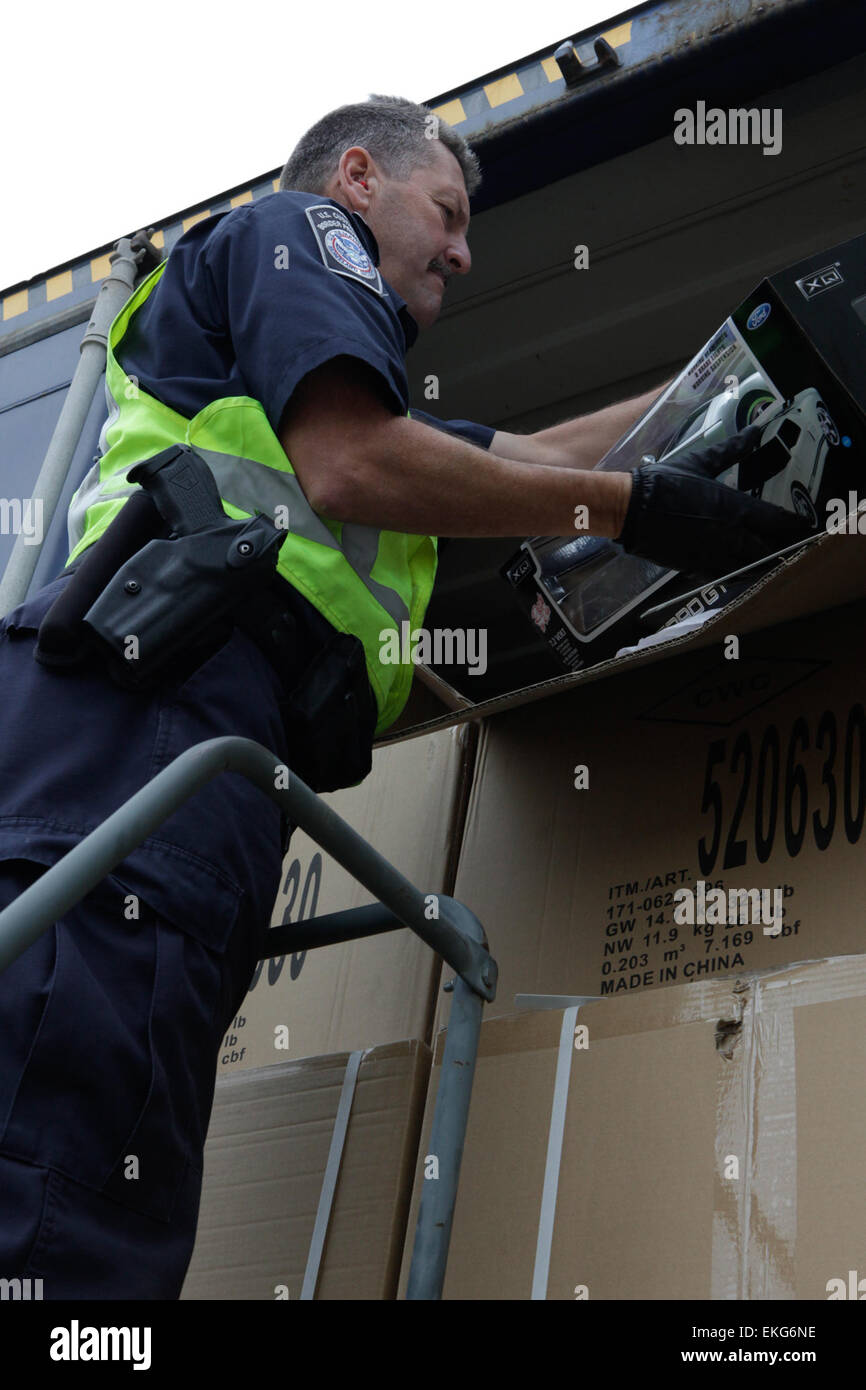 A U.S. Customs and Border Protection Field Officer inspects a vehicle ...