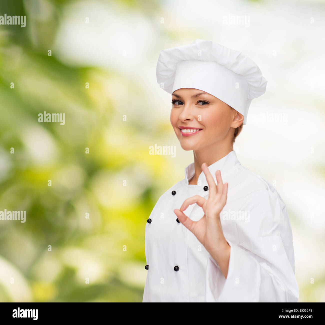smiling female chef showing ok hand sign Stock Photo - Alamy