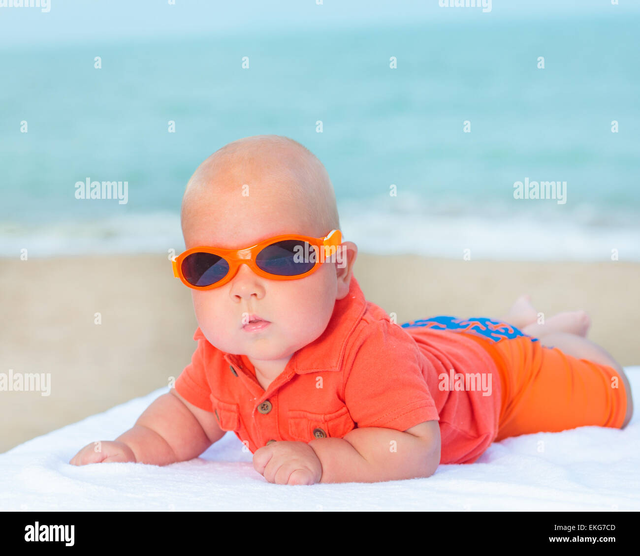 Cute baby wearing sunglasses on the sunbed Stock Photo Alamy