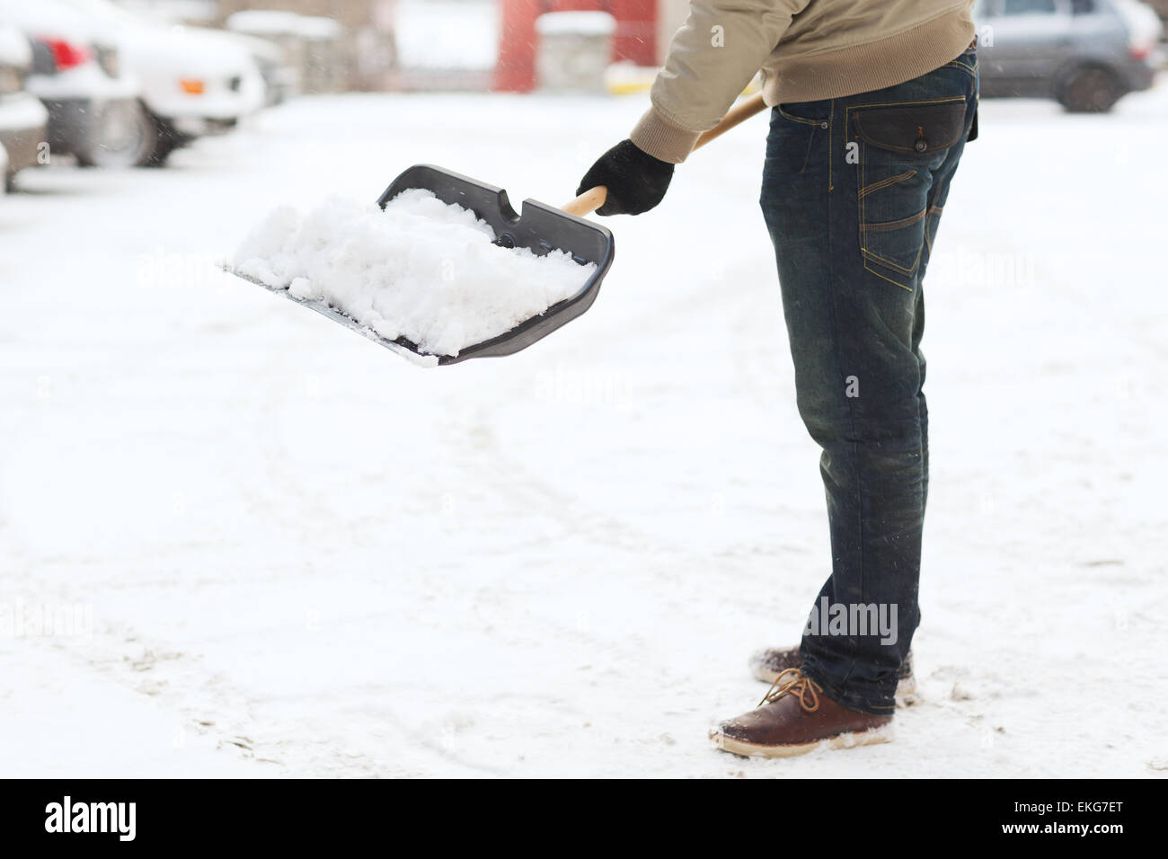 closeup of man shoveling snow from driveway Stock Photo Alamy