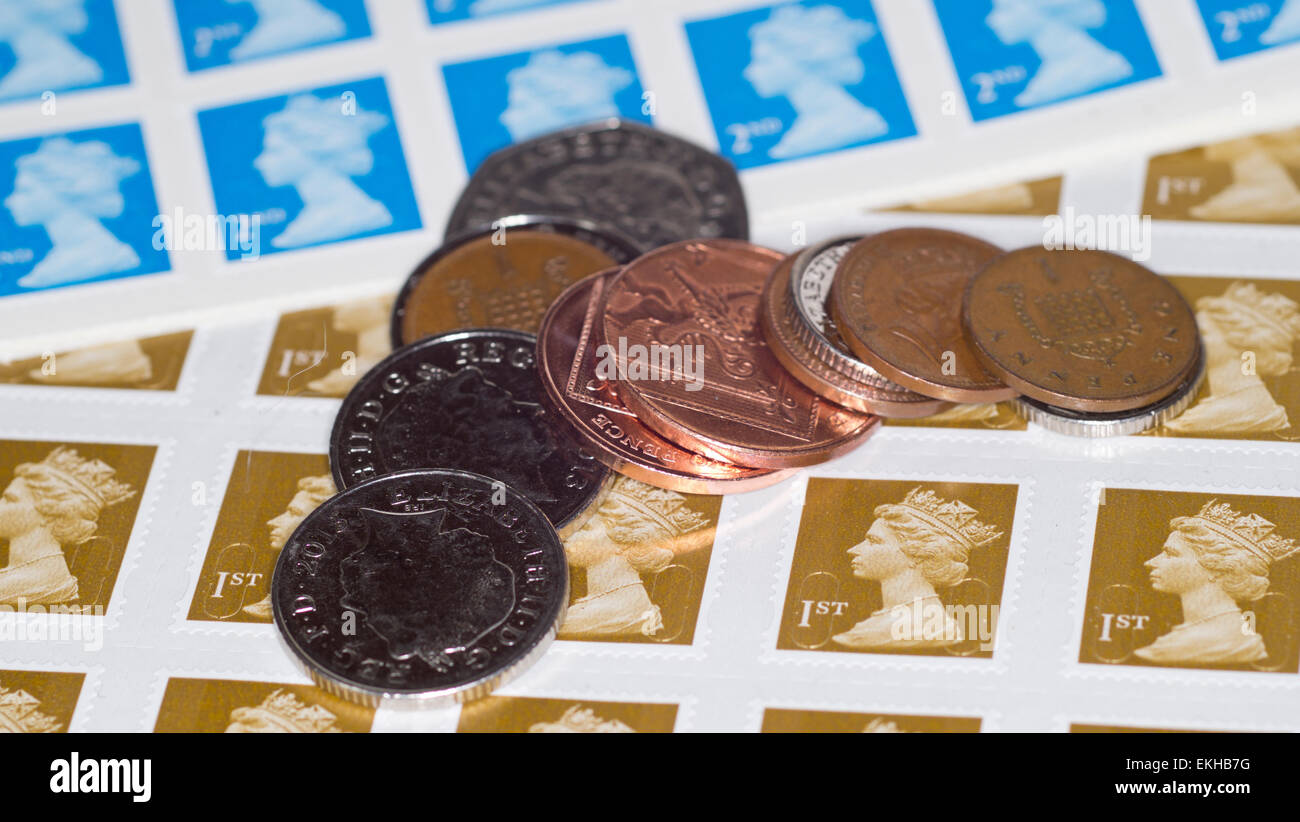 UK first and second class postage stamps, with coins Stock Photo Alamy