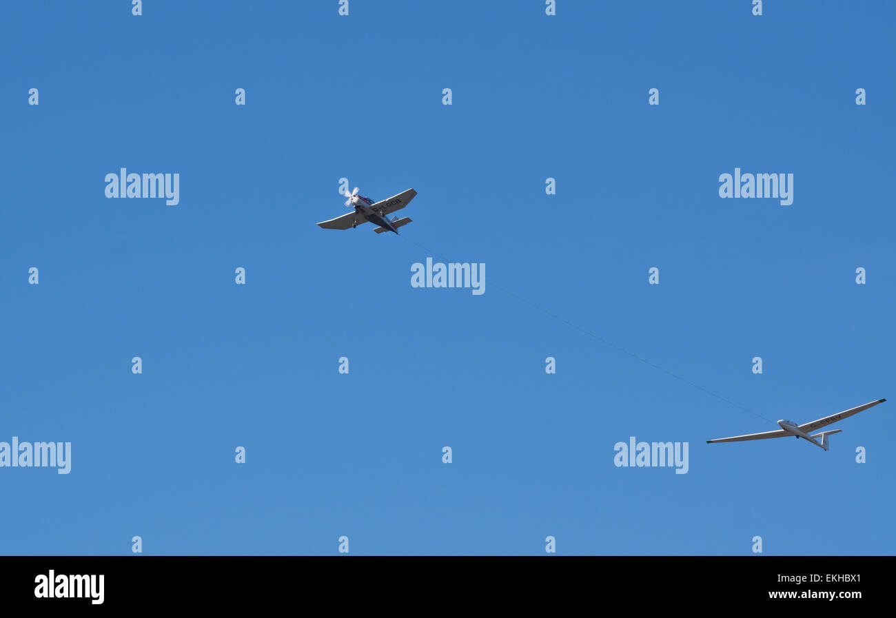 A plane towing a glider to flying height over Dunstable downs Stock