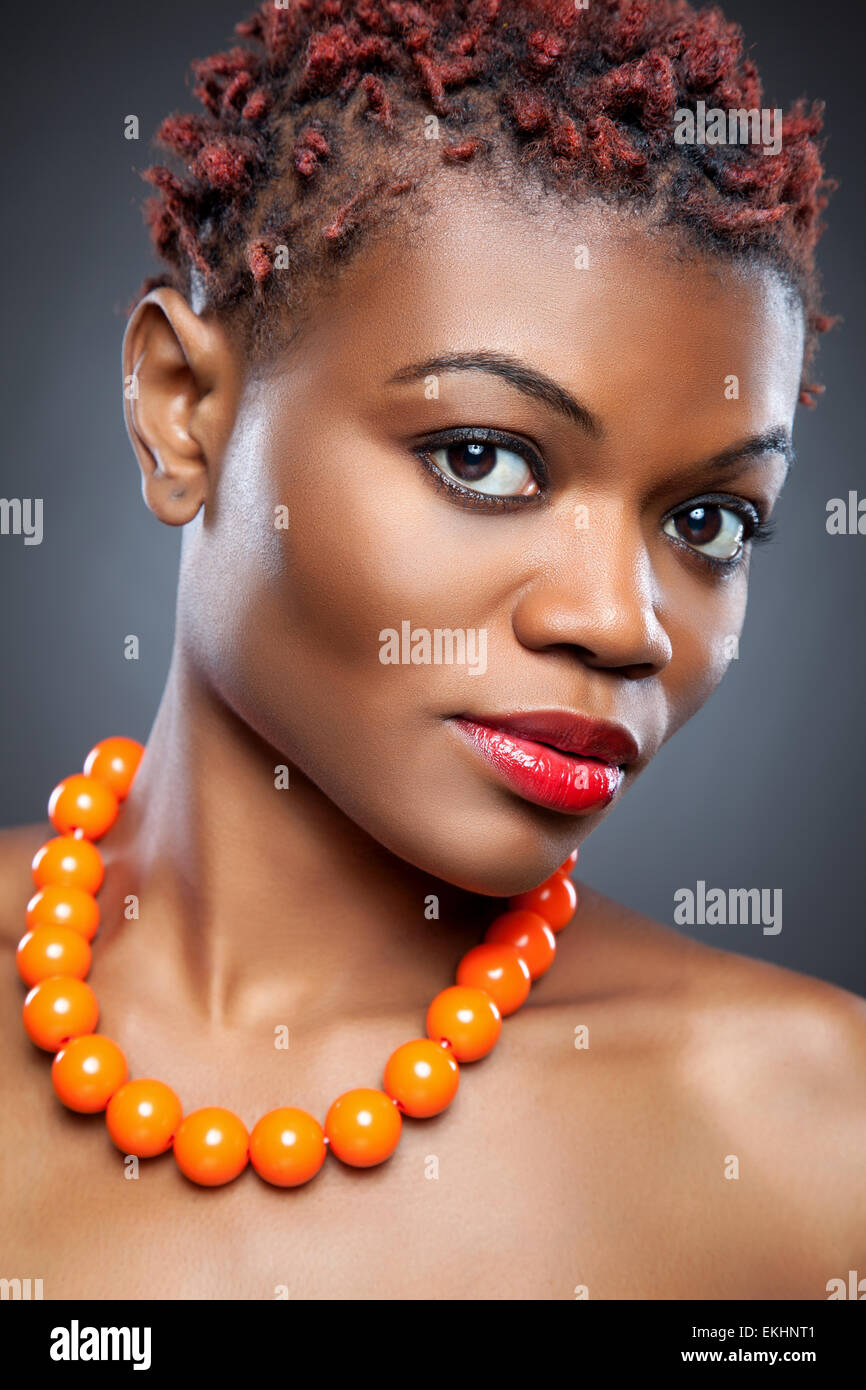 Black beauty with short spiky red hair Stock Photo - Alamy