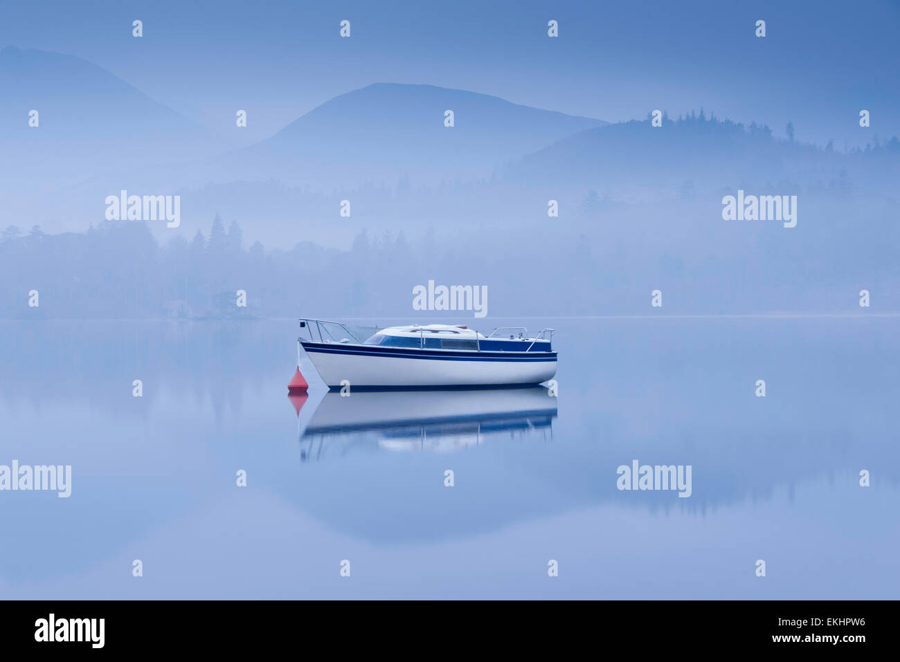 Boat on an early morning misty Derwentwater, Lake District, England Stock Photo