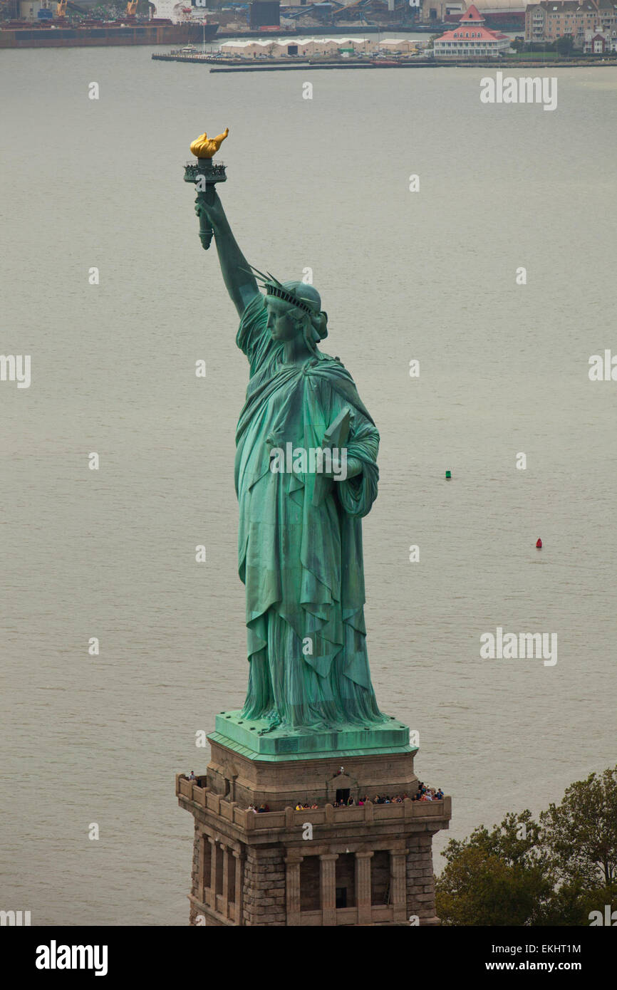 The Statue of Liberty stands off of Manhattan New York. Photo James