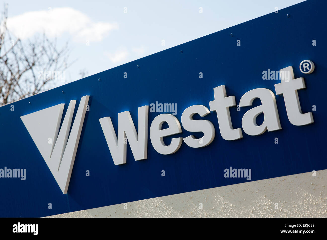 A logo sign on a building occupied by Westat. Stock Photo