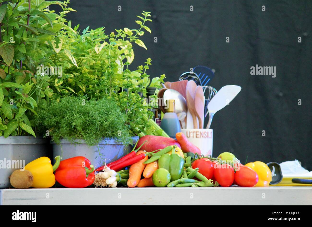 Kitchen vegetables, fruit, garden herbs, and utensils preparation for ...