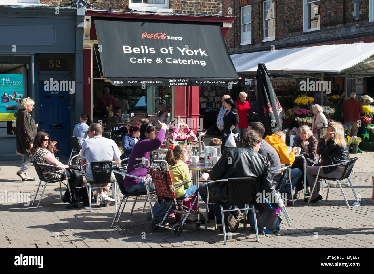 People sitting eating outside Bell's of York café, City of York, England, UK Stock Photo