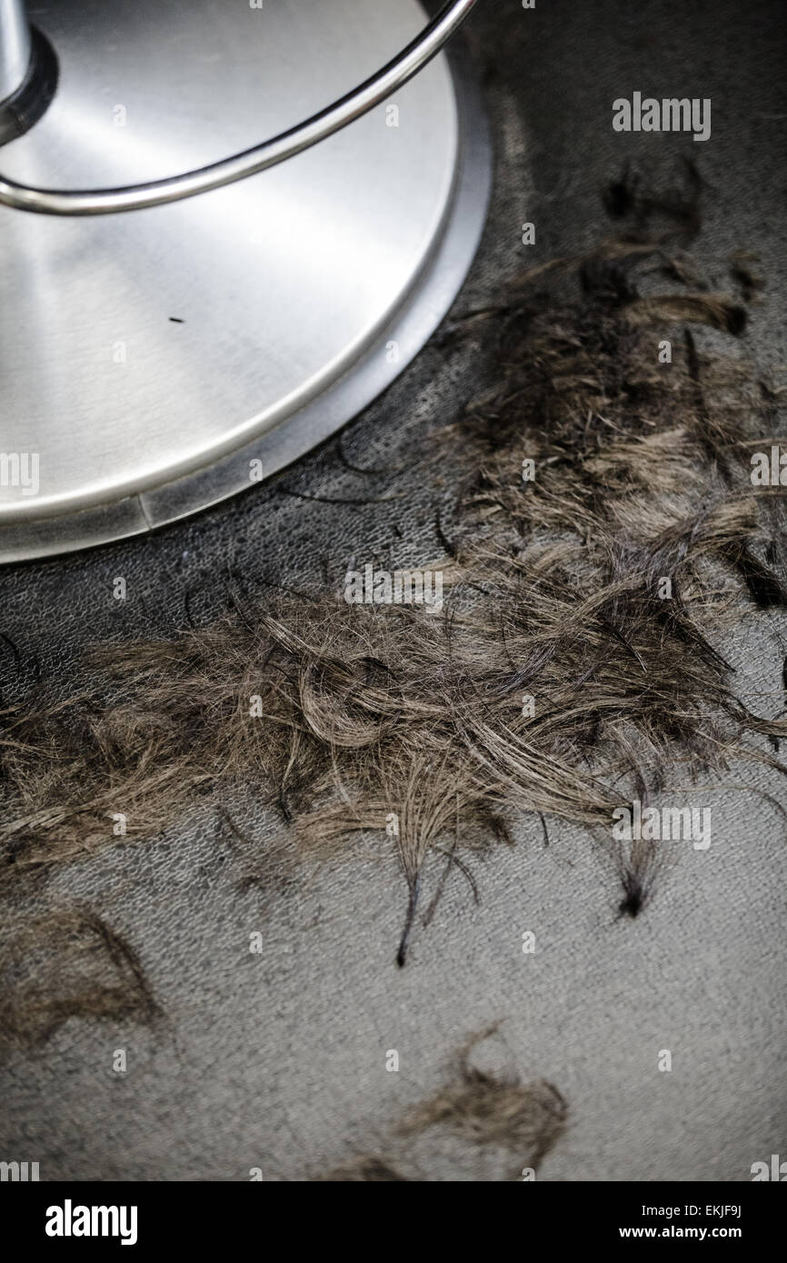 Hair Salon Chair Closeup with Hairs On the Floor Stock Photo