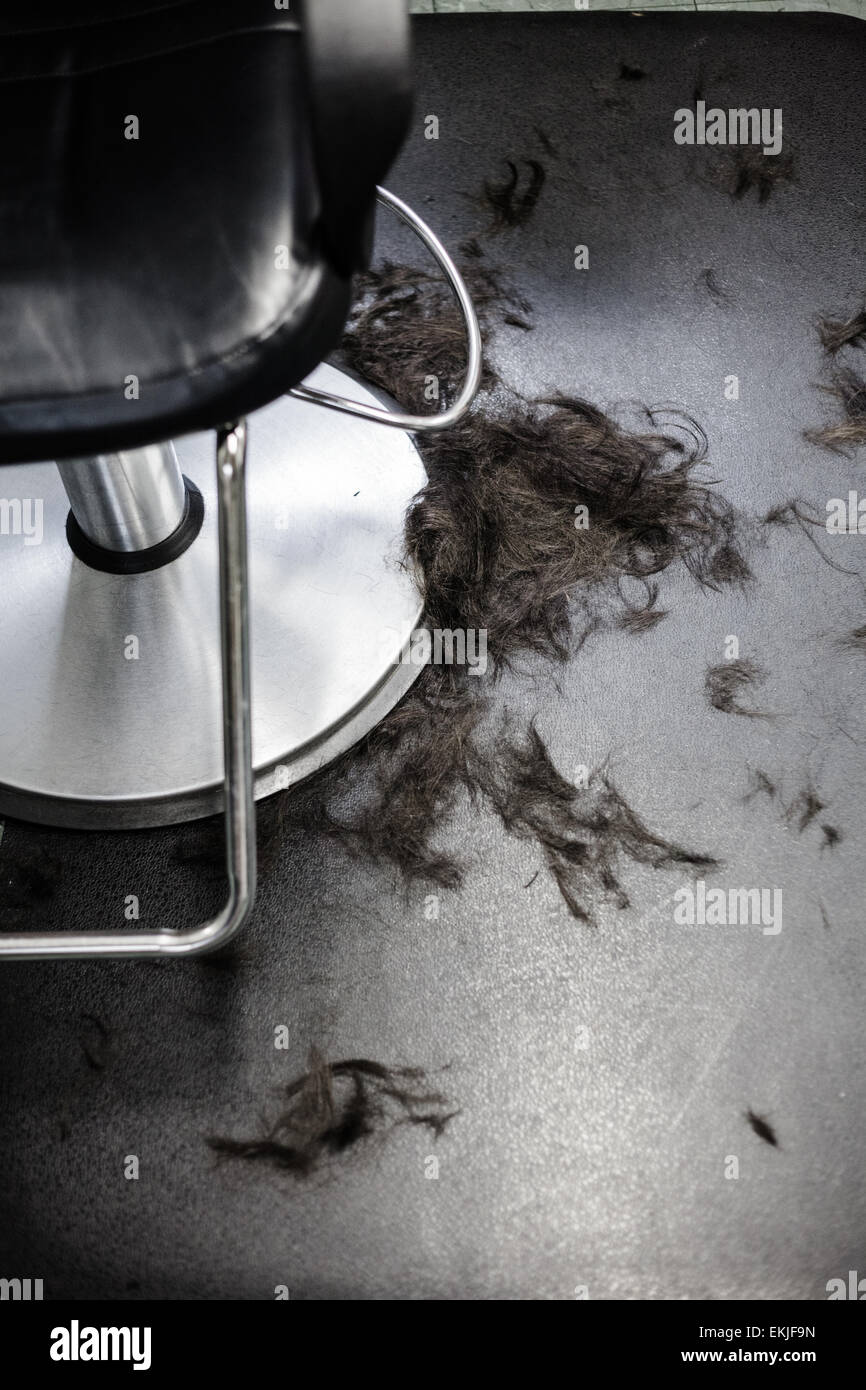 Hair Salon Chair Closeup With Hairs On The Floor Stock Photo