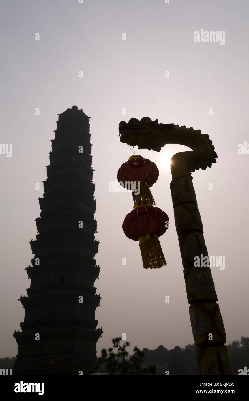 Sun tries to burn though morning fog on grounds of the Iron Pagoda, Kaifeng, Henan Province, China. Stock Photo
