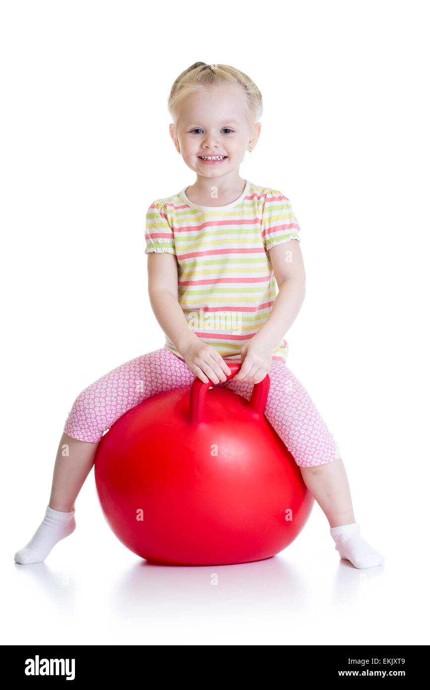 happy little girl jumping on bouncing ball Stock Photo