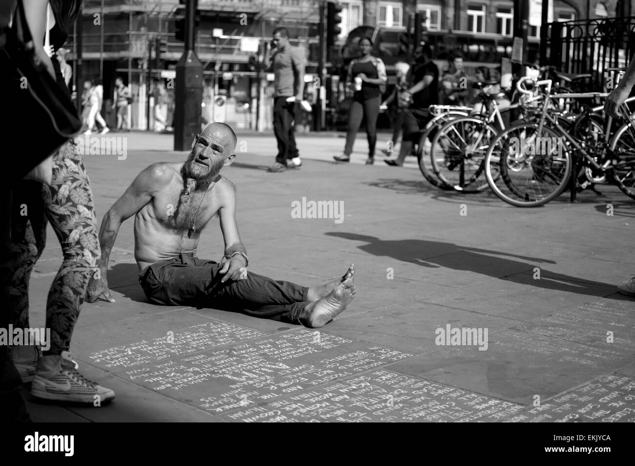 A street performer captured while talking to a passerby Stock Photo