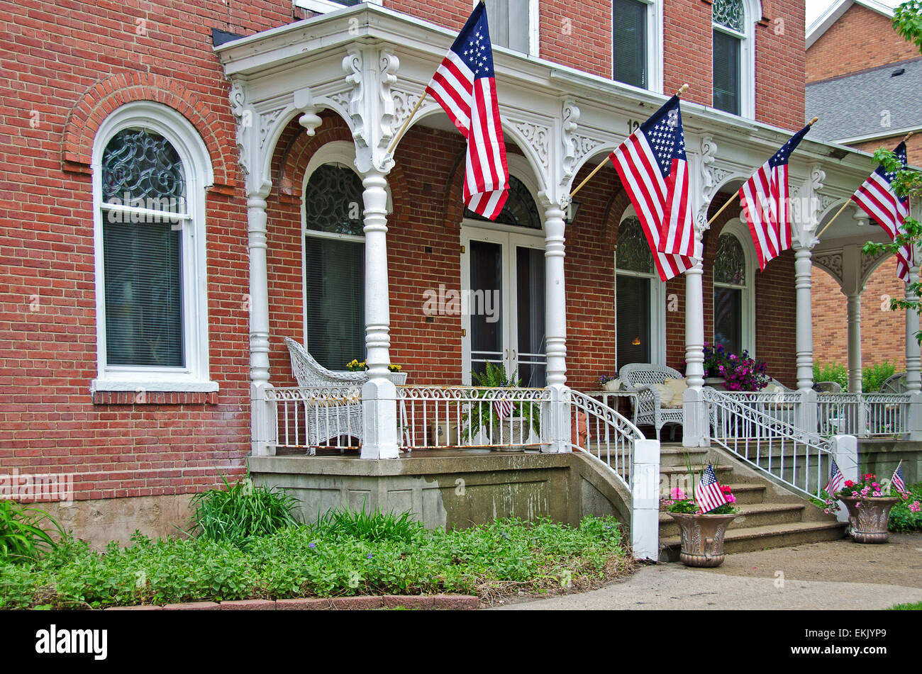 French Italianate mansion with American flags. Stock Photo
