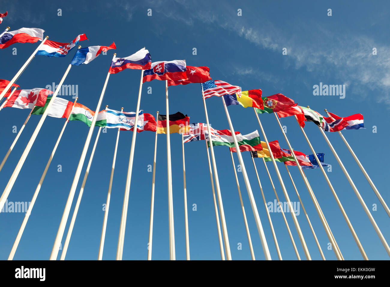 flags of different countries on flagpoles fluttering in the wind Stock Photo