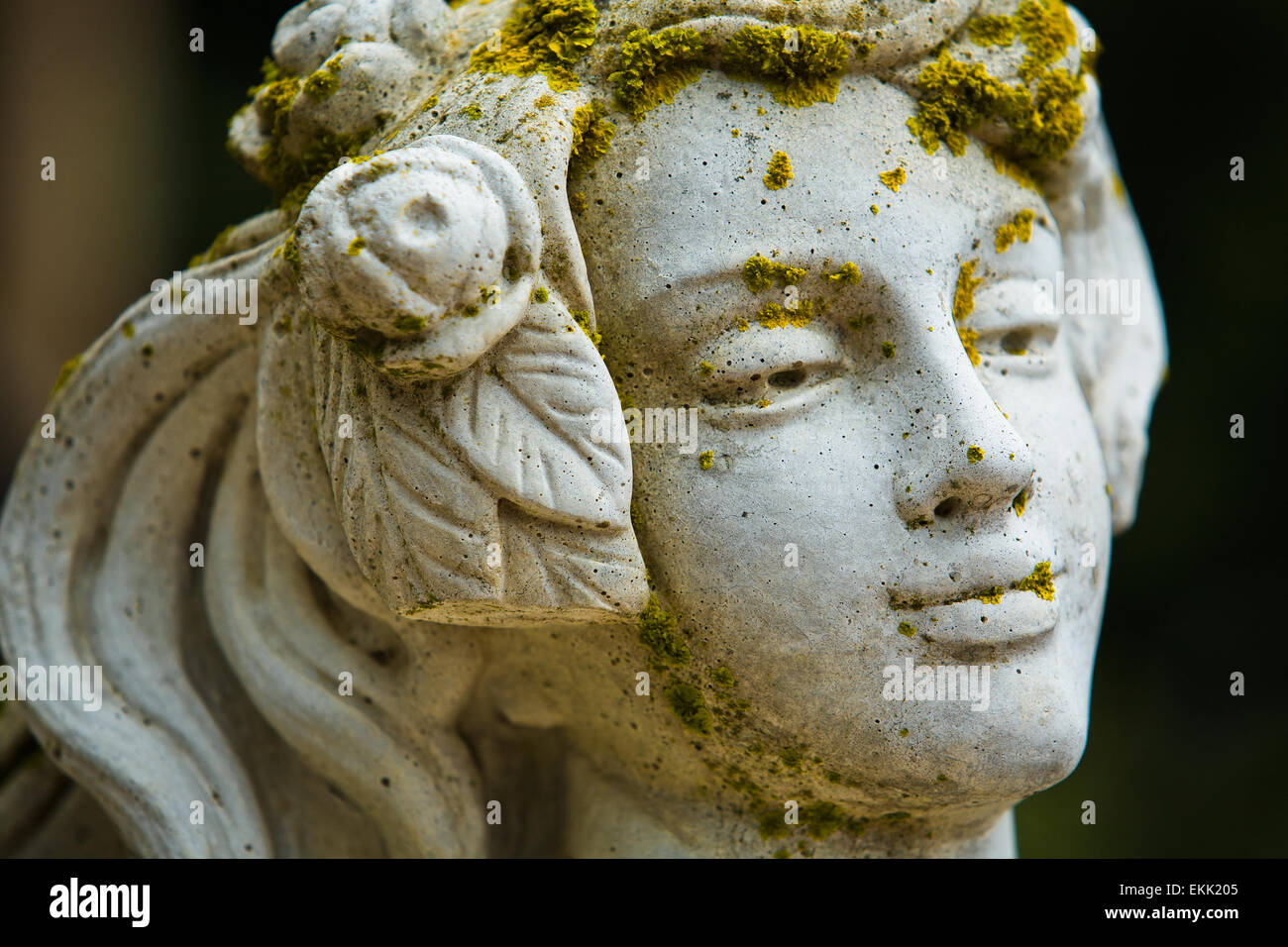 Young Female Garden Statue covered with  Moss and Lichen Stock Photo